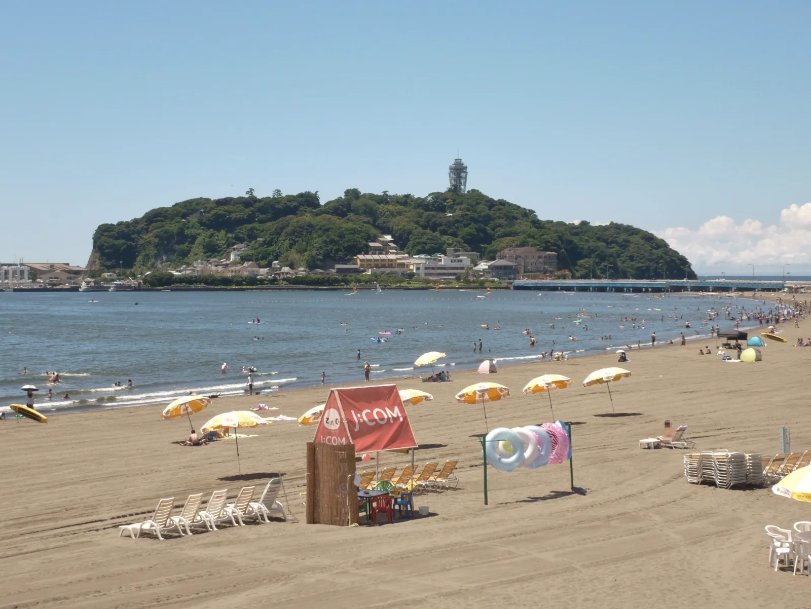 Enoshima island viewed from the beach with the Sea Candle observation tower on top