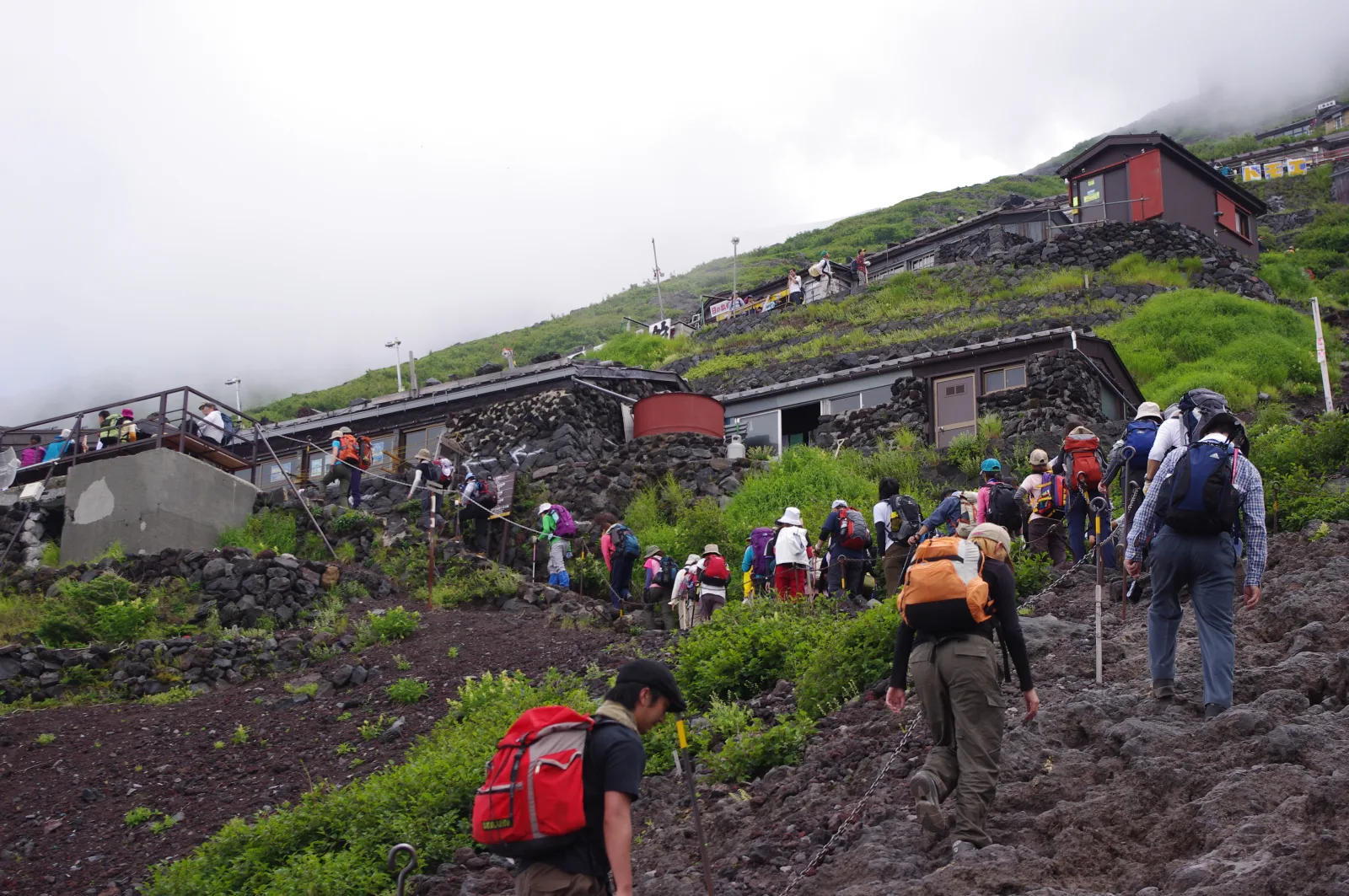 A line of climbers ascending the upper slopes of Mt. Fuji