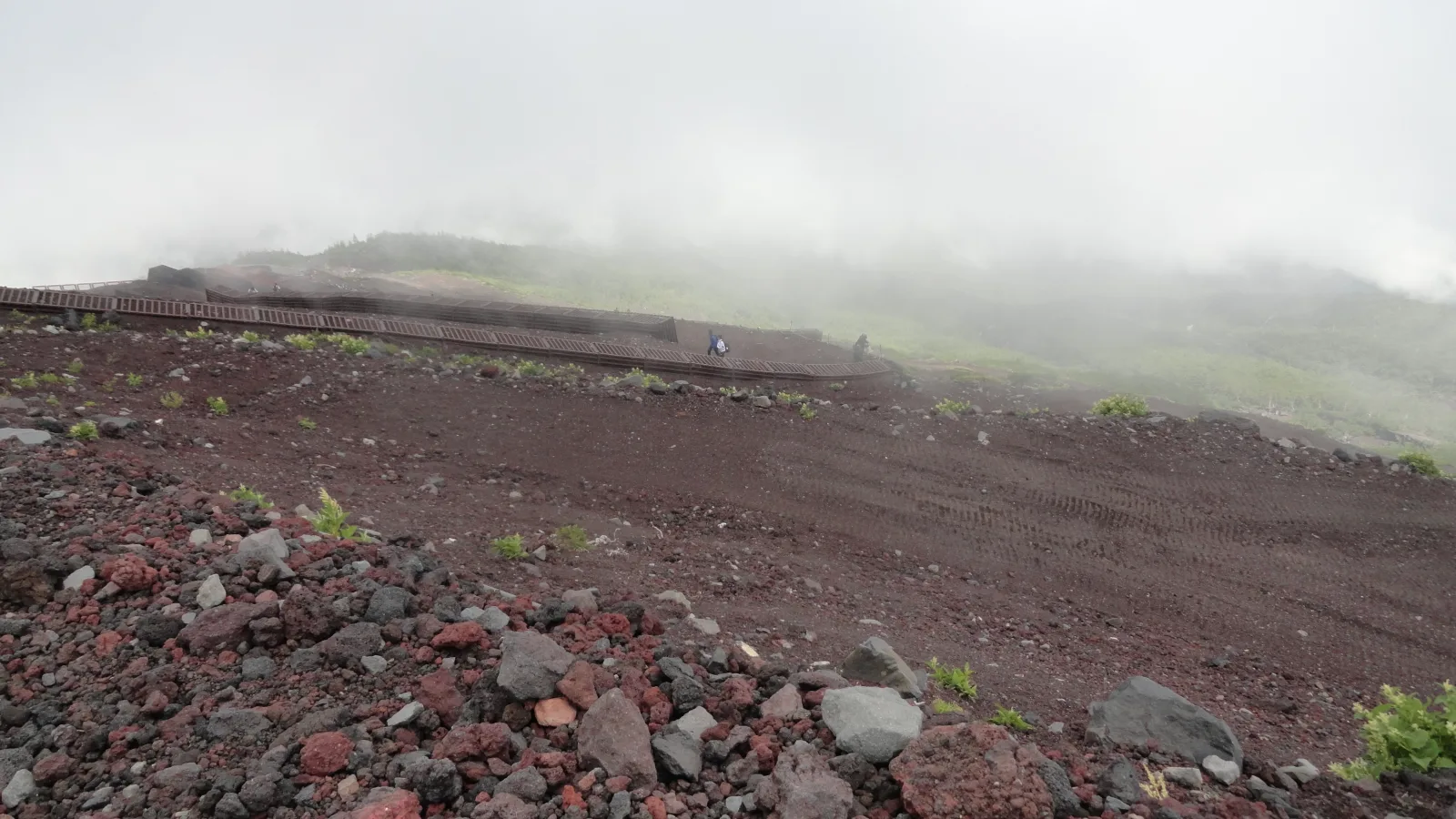 Climbers on the Yoshida Trail switchbacks high on Mt. Fuji
