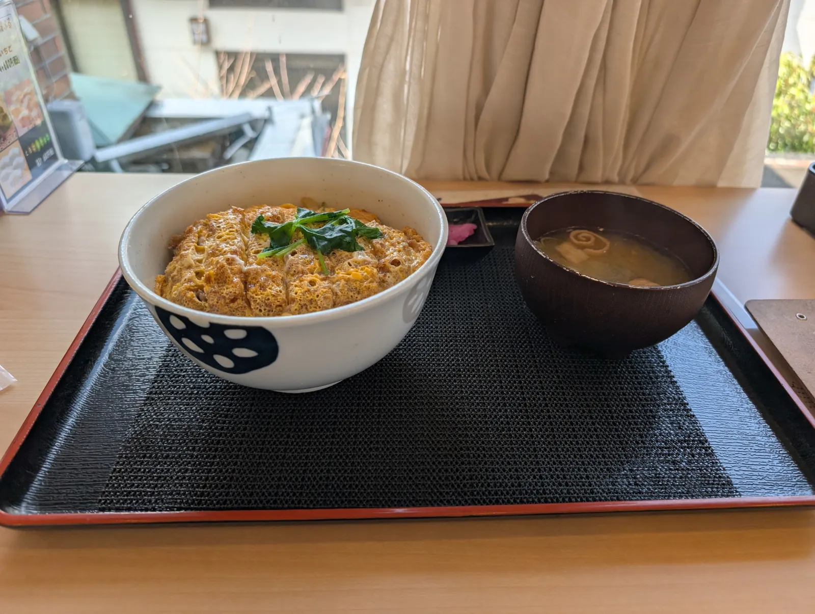 Un bol de katsudon con sopa miso en un restaurante local cerca de la estación de Nikko