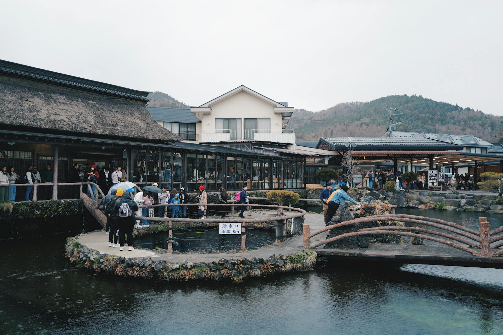 Tourists at Oshino Hakkai — the eight clear ponds and traditional village at the foot of Mt. Fuji on Route C