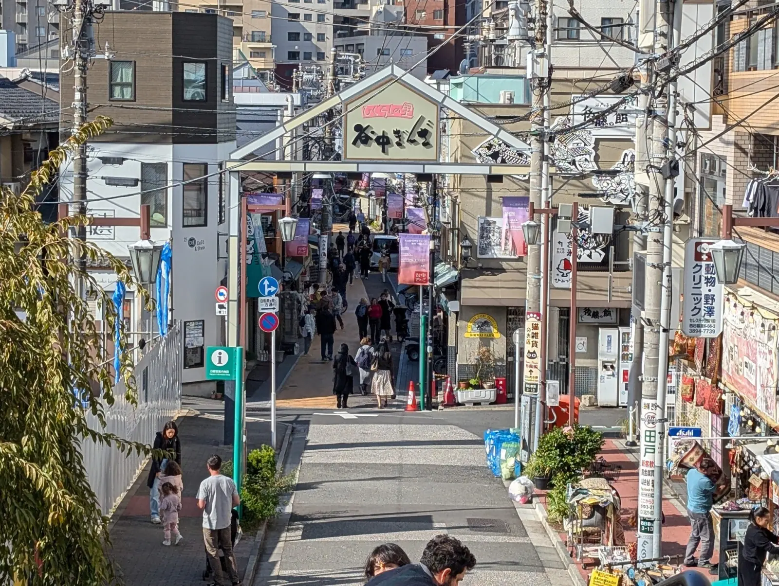 Entrance gate to Yanaka Ginza shopping street with local shoppers in old Tokyo