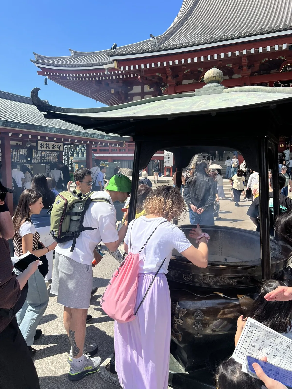 Guests bathing in healing incense smoke at the Senso-ji main hall cauldron