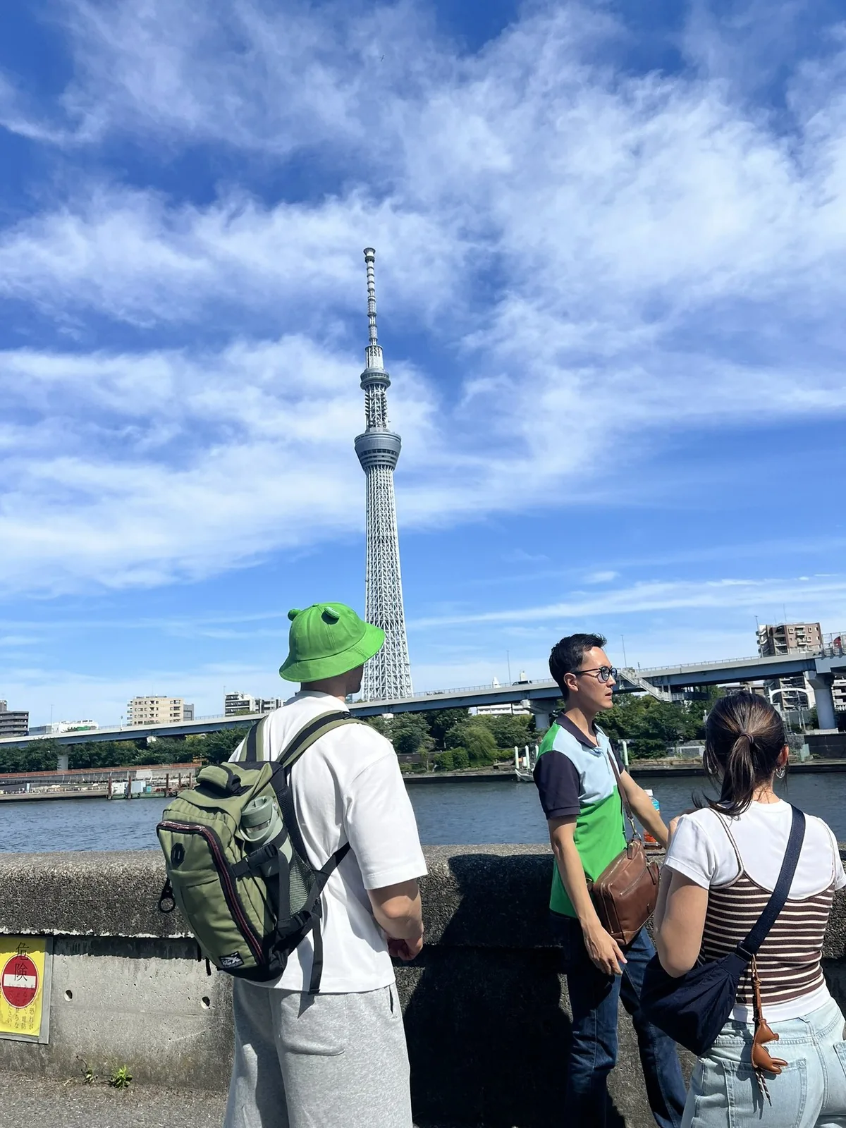 Manabu guiding a private family tour in Asakusa with Tokyo Skytree in the background