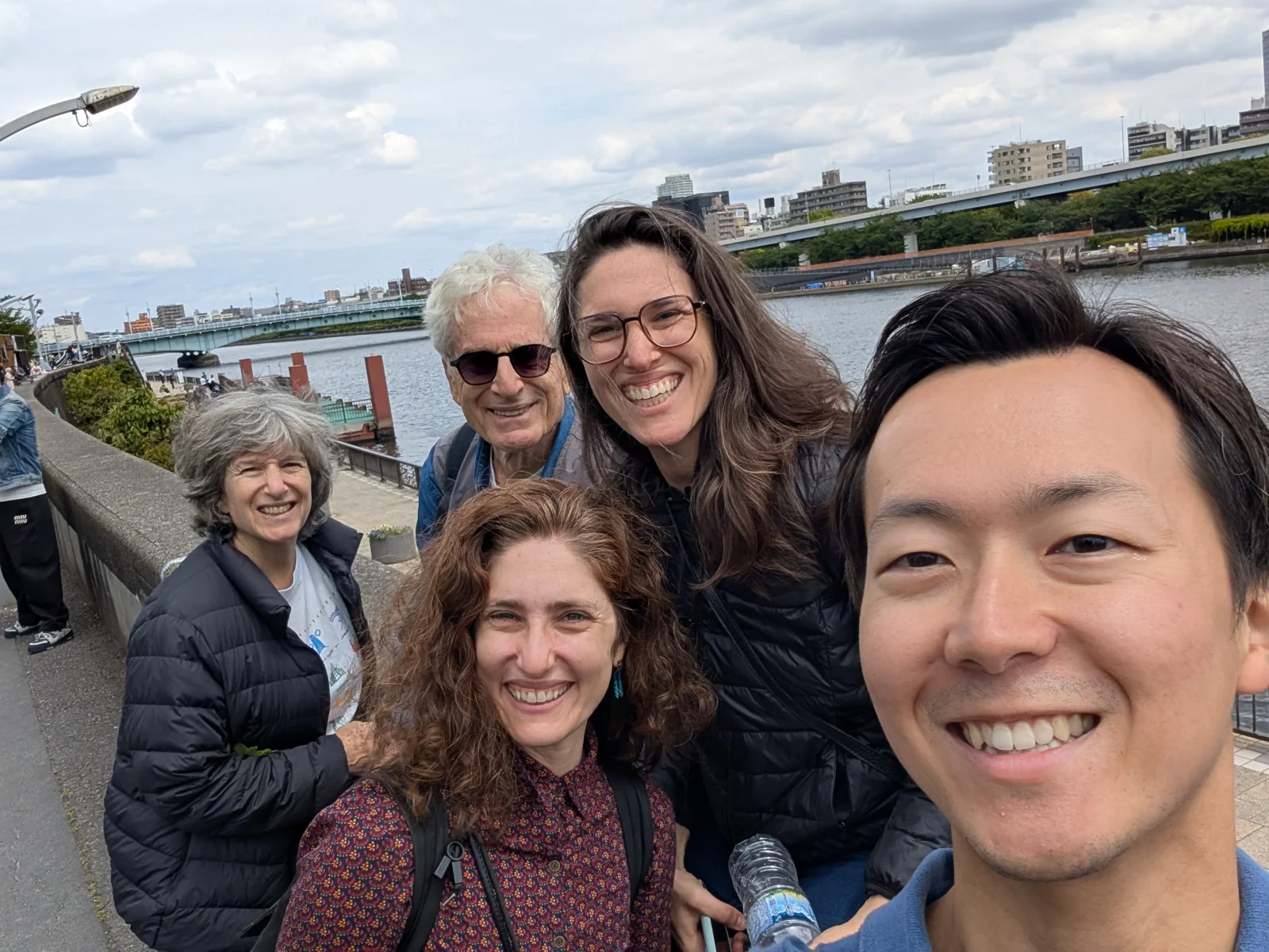 Manabu and tour guests pose for a selfie along the Sumida River in Tokyo