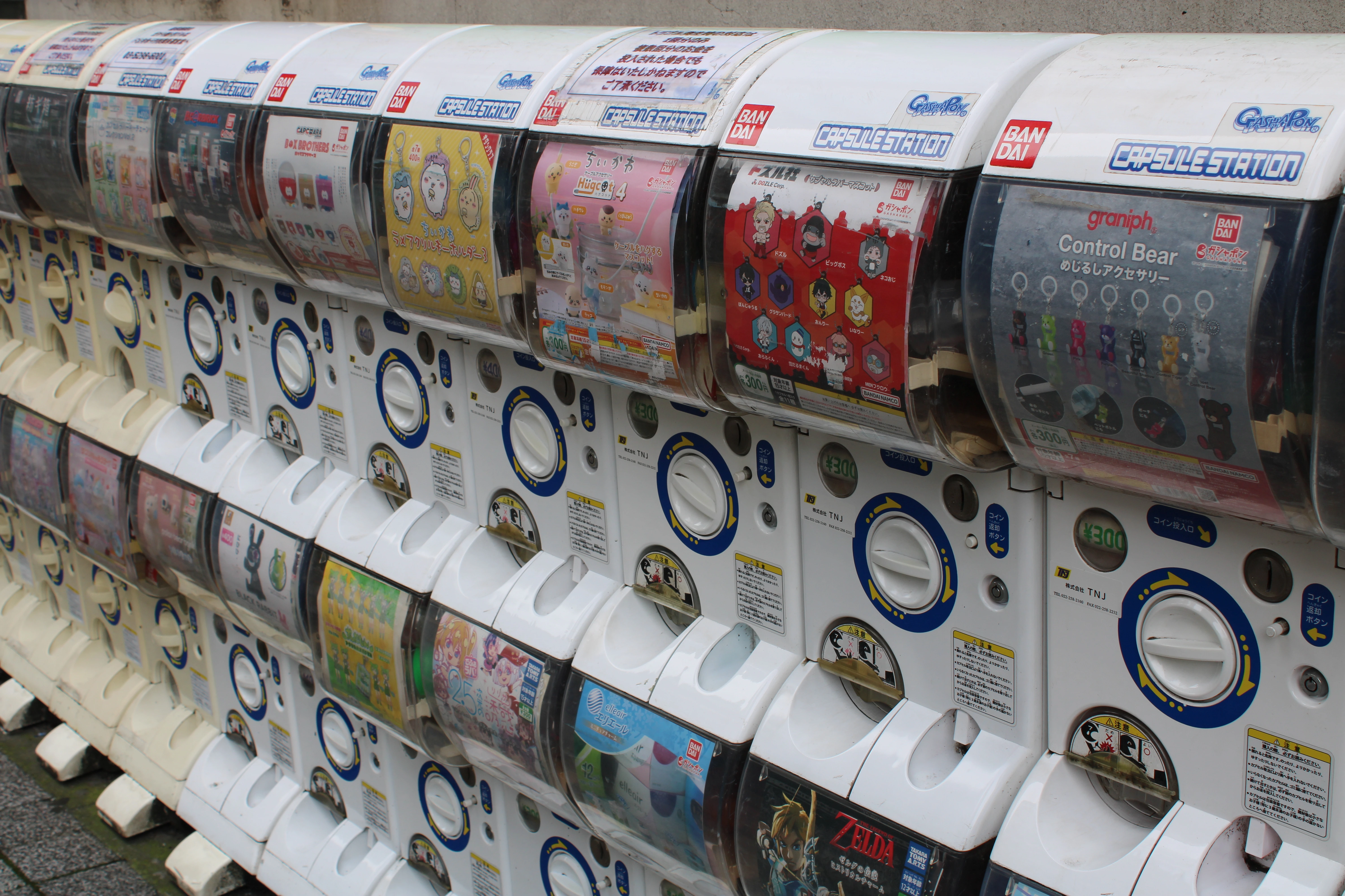 Rows of gatcha machines along the street